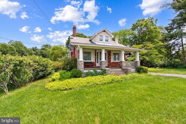 615 Convent Rd, Aston, PA 19014 - view of front facade with a porch, a chimney, and a front yard