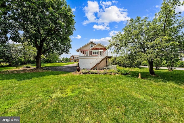 615 Convent Rd, Aston, PA 19014 - view of green lawn featuring stairs, a porch, and asphalt driveway
