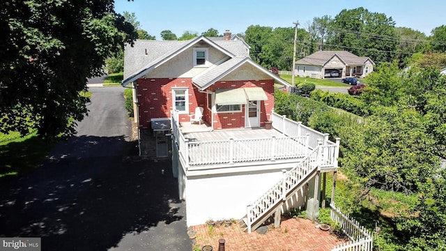 615 Convent Rd, Aston, PA 19014 - view of front facade featuring brick siding, a deck, and stairs