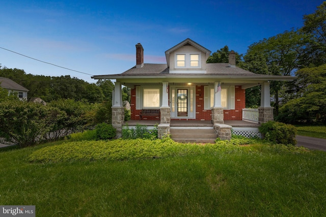 615 Convent Rd, Aston, PA 19014 - bungalow-style home with a chimney, a porch, and brick siding