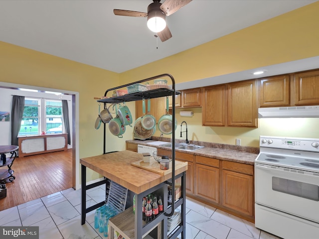 702 N Warren St, Orwigsburg, PA 17961 - kitchen featuring white electric stove, under cabinet range hood, light marble finish floors, and a ceiling fan