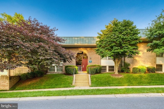 3622 Gleneagles Dr Unit 9-2C, Silver Spring, MD 20906 - view of front of house featuring a standing seam roof, a metal roof, brick siding, and a front yard