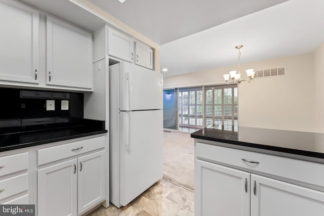 3622 Gleneagles Dr Unit 9-2C, Silver Spring, MD 20906 - kitchen with freestanding refrigerator, dark countertops, a chandelier, and white cabinetry