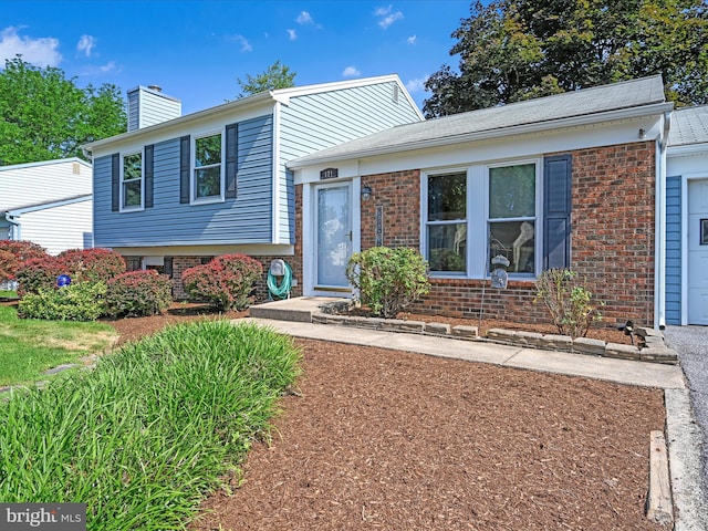 171 Tanglewood Ln, Lancaster, PA 17601 - split level home with a chimney and brick siding