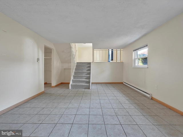 171 Tanglewood Ln, Lancaster, PA 17601 - below grade area with a baseboard heating unit, stairs, a textured ceiling, and light tile patterned floors