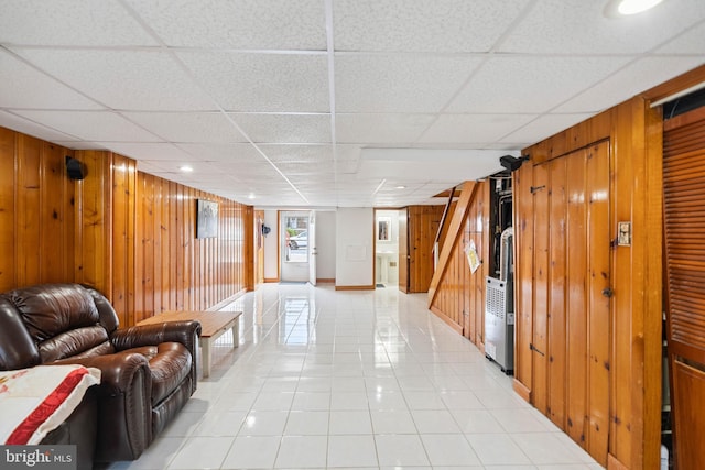 2847 S 65th St, Philadelphia, PA 19142 - living room with wooden walls, light tile patterned flooring, and a drop ceiling