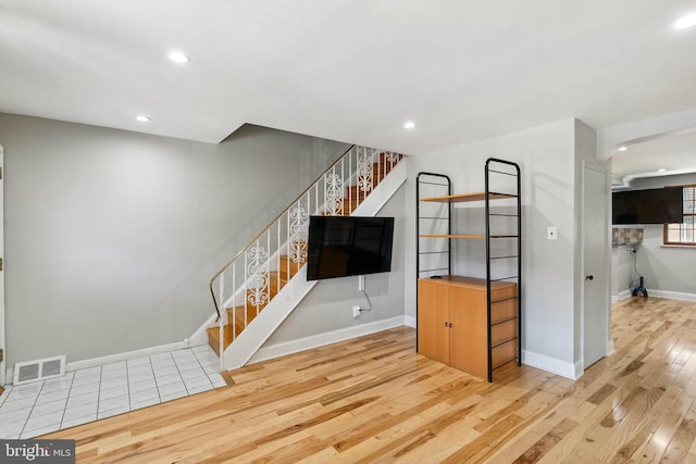 2847 S 65th St, Philadelphia, PA 19142 - unfurnished living room with light wood-type flooring, stairs, and recessed lighting