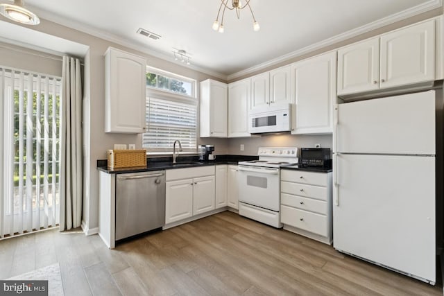 44203 Litchfield Ter, Ashburn, VA 20147 - kitchen with white appliances, white cabinetry, dark countertops, light wood-style flooring, and crown molding