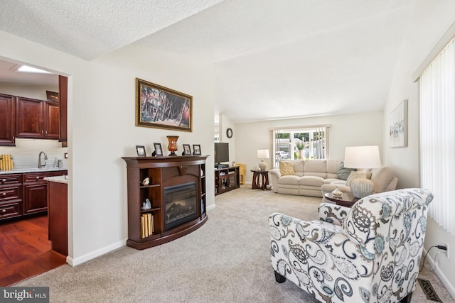 656 Windsor Ave, Maple Shade, NJ 08052 - living room featuring dark carpet, lofted ceiling, and a glass covered fireplace