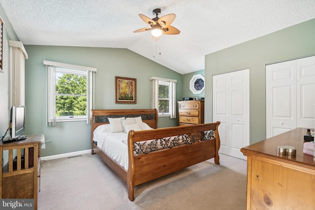 656 Windsor Ave, Maple Shade, NJ 08052 - bedroom with light colored carpet, lofted ceiling, multiple closets, a textured ceiling, and ceiling fan