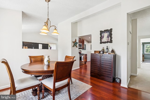 656 Windsor Ave, Maple Shade, NJ 08052 - dining room with wood finished floors, a bar, a textured ceiling, and a chandelier