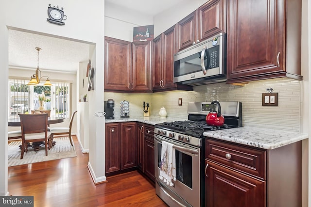 656 Windsor Ave, Maple Shade, NJ 08052 - kitchen featuring stainless steel appliances, decorative backsplash, dark wood-style floors, and light stone countertops