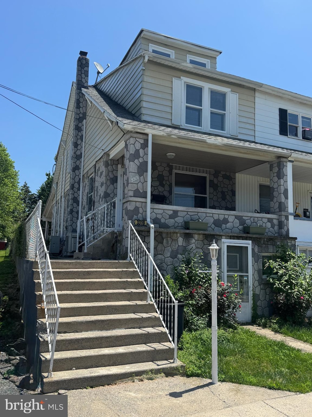 3319 Holtry St, Reading, PA 19605 - view of front of property with a chimney, stone siding, a porch, and stairs