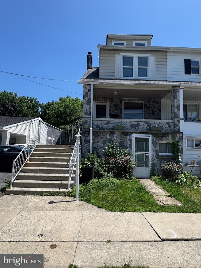 3319 Holtry St, Reading, PA 19605 - view of property featuring stairs, a chimney, and stone siding