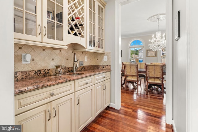 3213 Hatton Rd, Baltimore, MD 21208 - kitchen with cream cabinets, dark wood-type flooring, tasteful backsplash, stone countertops, and a chandelier