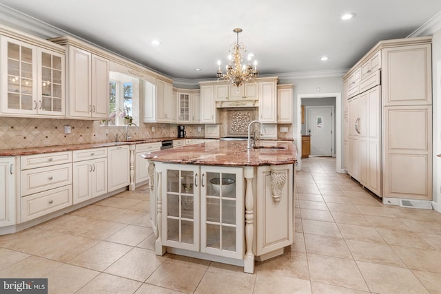 3213 Hatton Rd, Baltimore, MD 21208 - kitchen featuring cream cabinetry, crown molding, a chandelier, light tile patterned floors, and tasteful backsplash