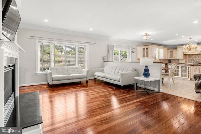 3213 Hatton Rd, Baltimore, MD 21208 - living area featuring hardwood / wood-style flooring, crown molding, a chandelier, a fireplace, and recessed lighting