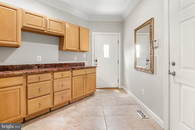3213 Hatton Rd, Baltimore, MD 21208 - kitchen featuring ornamental molding, light tile patterned flooring, light brown cabinetry, and dark stone countertops