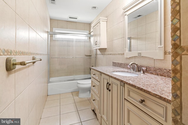 3213 Hatton Rd, Baltimore, MD 21208 - full bathroom with tile walls, vanity, tile patterned floors, bath / shower combo with glass door, and backsplash