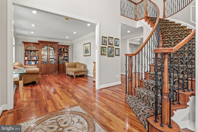 3213 Hatton Rd, Baltimore, MD 21208 - entrance foyer featuring wood finished floors, ornamental molding, recessed lighting, and stairs