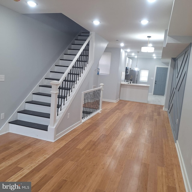 1716 N Monroe St, Baltimore, MD 21217 - unfurnished living room with stairway and light wood-type flooring