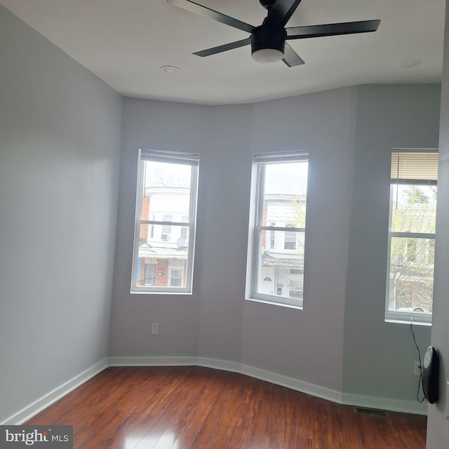 1716 N Monroe St, Baltimore, MD 21217 - empty room with dark wood finished floors and a ceiling fan