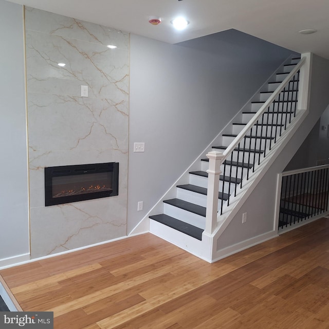 1716 N Monroe St, Baltimore, MD 21217 - stairway featuring wood finished floors and a fireplace