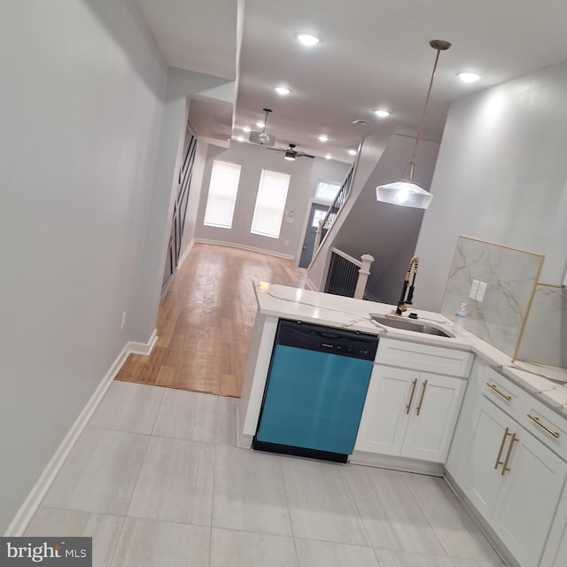 1716 N Monroe St, Baltimore, MD 21217 - kitchen with dishwashing machine, a peninsula, white cabinetry, open floor plan, and hanging light fixtures