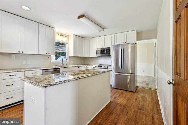 1207 Avalon Blvd, Shady Side, MD 20764 - kitchen with appliances with stainless steel finishes, dark wood finished floors, white cabinetry, and light stone countertops