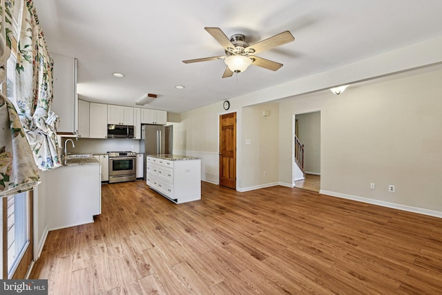1207 Avalon Blvd, Shady Side, MD 20764 - kitchen featuring appliances with stainless steel finishes, a kitchen island, white cabinetry, light wood-style floors, and recessed lighting