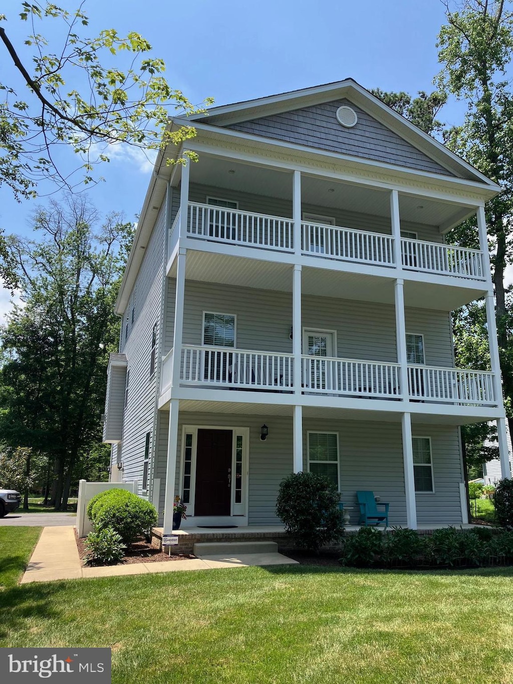 7005 Myrtle Ave, North Beach, MD 20714 - view of front facade with a balcony and a front lawn