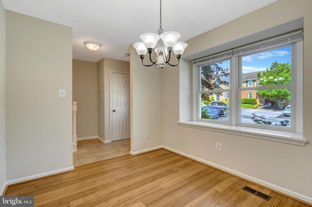504 Pow Morr Dr, Front Royal, VA 22630 - unfurnished room with a chandelier and light wood-style flooring