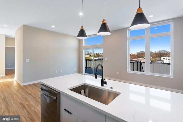 1358 Florida Ave NE Unit Ph-02, Washington, DC 20002 - kitchen with dishwasher, light wood-style flooring, decorative light fixtures, light stone countertops, and recessed lighting