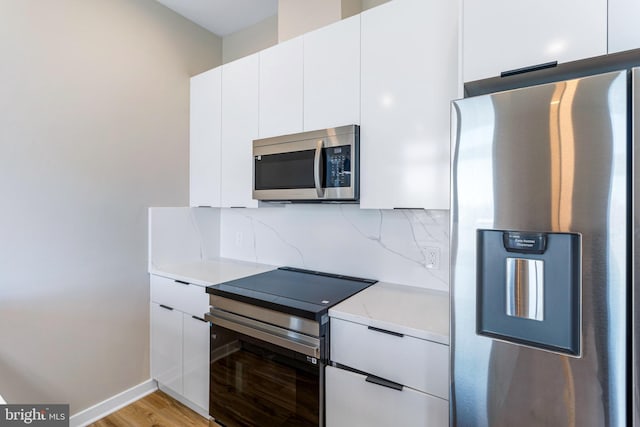 1358 Florida Ave NE Unit Ph-02, Washington, DC 20002 - kitchen featuring stainless steel appliances, light countertops, decorative backsplash, and white cabinetry