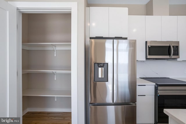 1358 Florida Ave NE Unit Ph-02, Washington, DC 20002 - kitchen featuring stainless steel appliances, wood finished floors, white cabinetry, light countertops, and modern cabinets