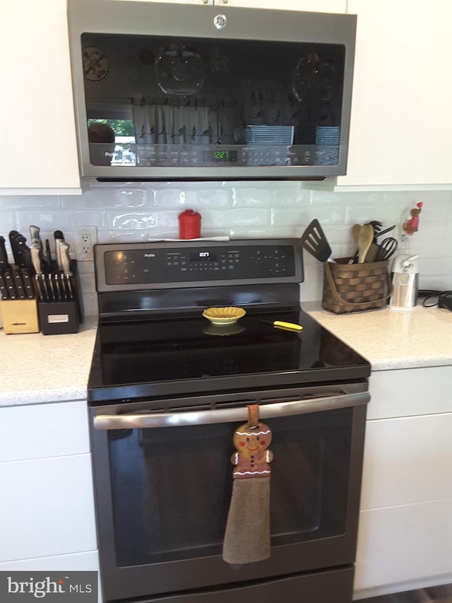295 Bridgewater Cir, Fredericksburg, VA 22406 - kitchen with appliances with stainless steel finishes, backsplash, and white cabinets