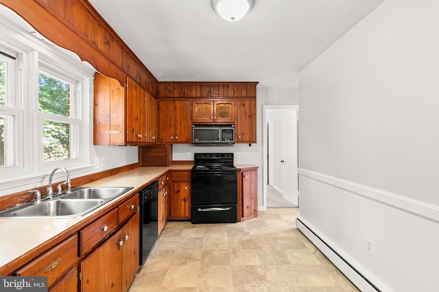 102 Deaven Rd, Harrisburg, PA 17112 - kitchen featuring black appliances, a baseboard heating unit, light countertops, brown cabinets, and stone finish flooring