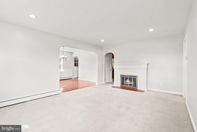 102 Deaven Rd, Harrisburg, PA 17112 - unfurnished living room featuring arched walkways, carpet flooring, a baseboard heating unit, recessed lighting, and a fireplace with flush hearth