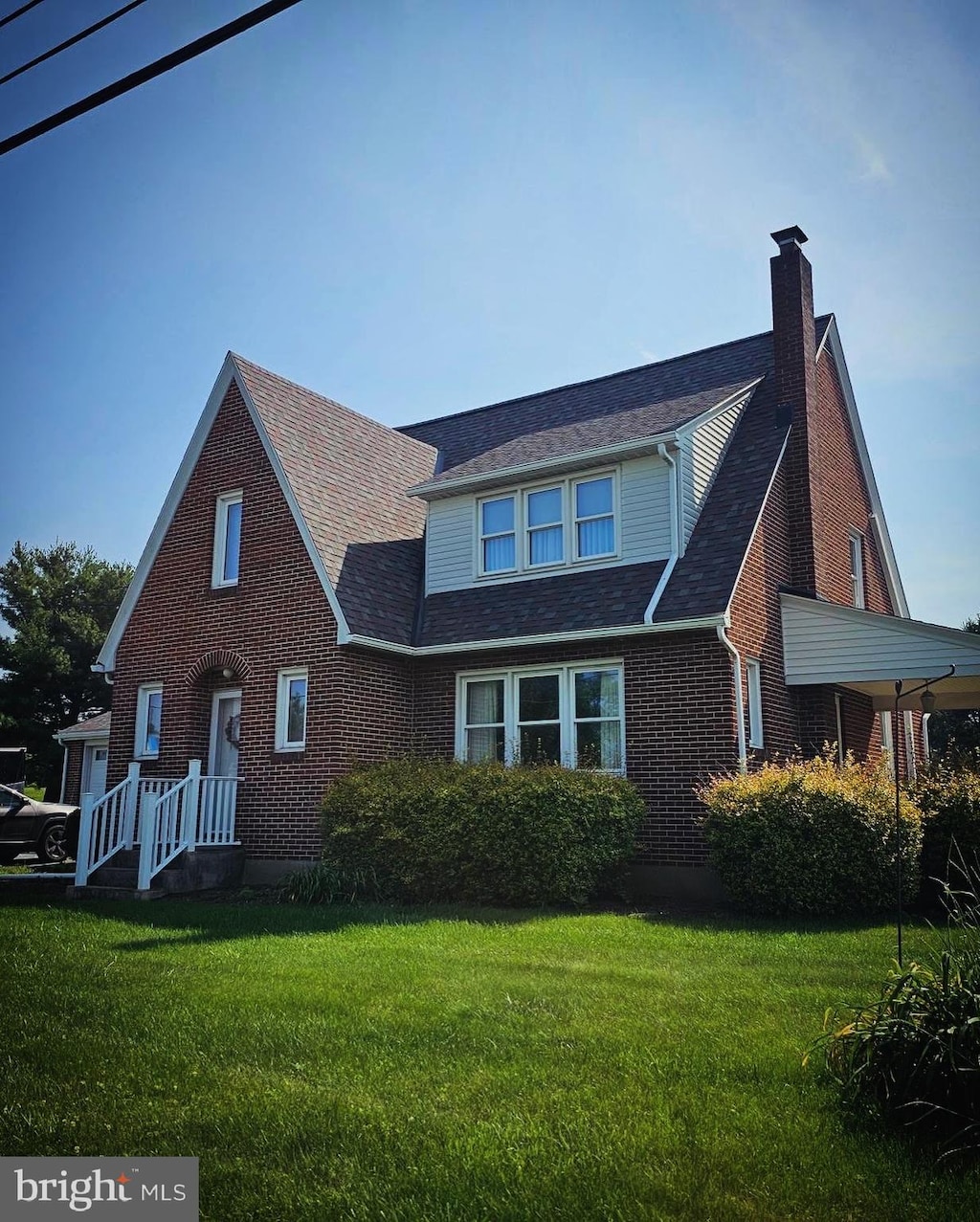 1954 Laudermilch Rd, Palmyra, PA 17078 - view of front facade with a chimney, a front yard, and brick siding