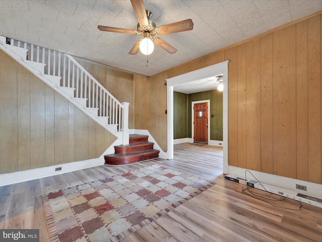 234 N Coal St, Port Carbon, PA 17965 - foyer featuring a ceiling fan, stairs, wood finished floors, and wood walls
