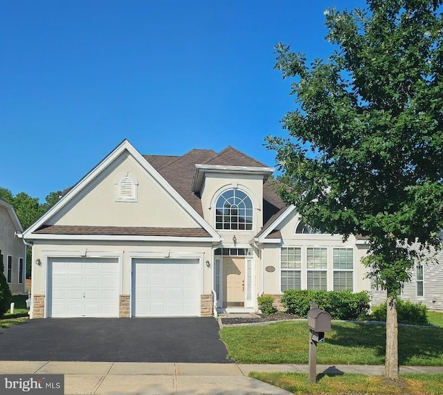 7 Honeysuckle Dr, Manahawkin, NJ 08005 - traditional home with driveway, stucco siding, a garage, and stone siding