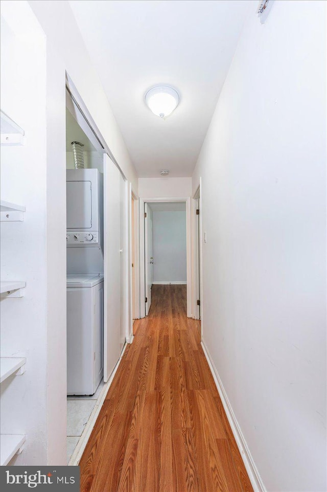 18503 Nutmeg Pl, Germantown, MD 20874 - hallway featuring stacked washer and clothes dryer and light wood-type flooring