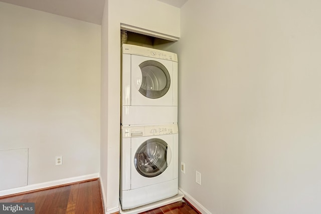 8218 Carrleigh Pkwy Unit 10, Springfield, VA 22152 - washroom with stacked washer / dryer and wood finished floors