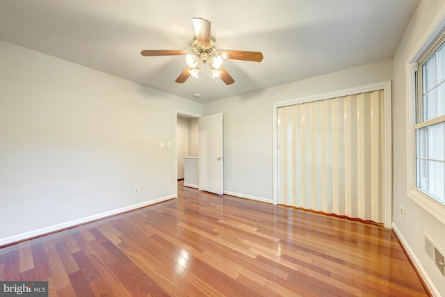 8218 Carrleigh Pkwy Unit 10, Springfield, VA 22152 - unfurnished bedroom with wood finished floors, multiple windows, and a ceiling fan