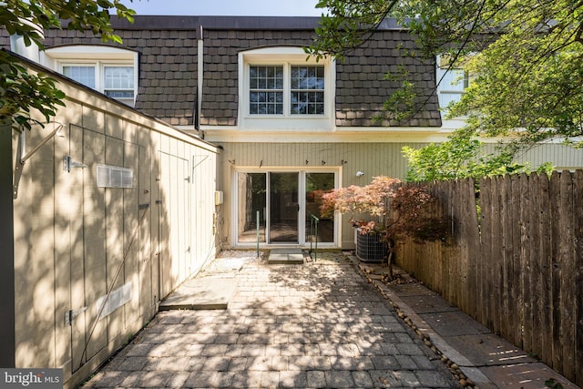 8218 Carrleigh Pkwy Unit 10, Springfield, VA 22152 - rear view of property featuring mansard roof and a patio