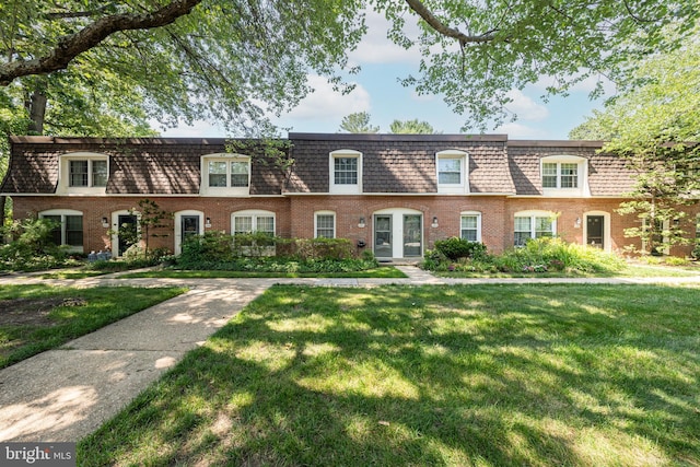 8218 Carrleigh Pkwy Unit 10, Springfield, VA 22152 - view of front facade with mansard roof, brick siding, and a front yard