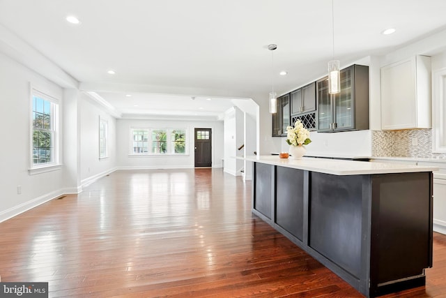 228 Warren Blvd, Broomall, PA 19008 - kitchen with light countertops, a center island, wood finished floors, glass insert cabinets, and recessed lighting