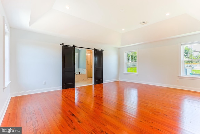228 Warren Blvd, Broomall, PA 19008 - unfurnished room featuring light wood-type flooring, healthy amount of natural light, a barn door, and recessed lighting