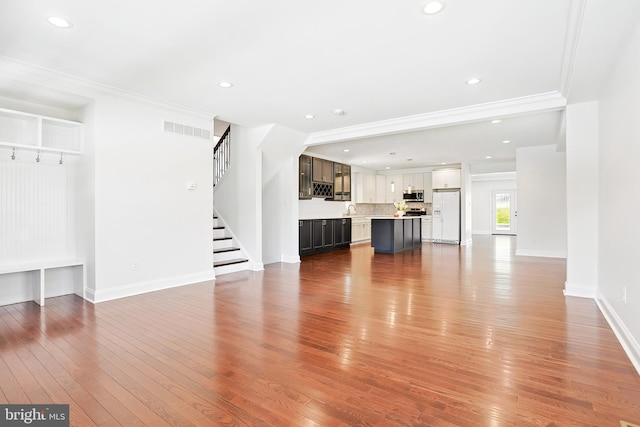 228 Warren Blvd, Broomall, PA 19008 - unfurnished living room featuring ornamental molding, hardwood / wood-style floors, stairway, and recessed lighting