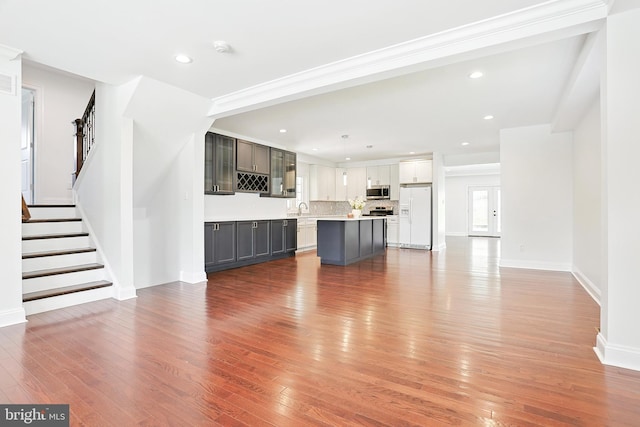 228 Warren Blvd, Broomall, PA 19008 - unfurnished living room featuring hardwood / wood-style flooring, stairway, and recessed lighting